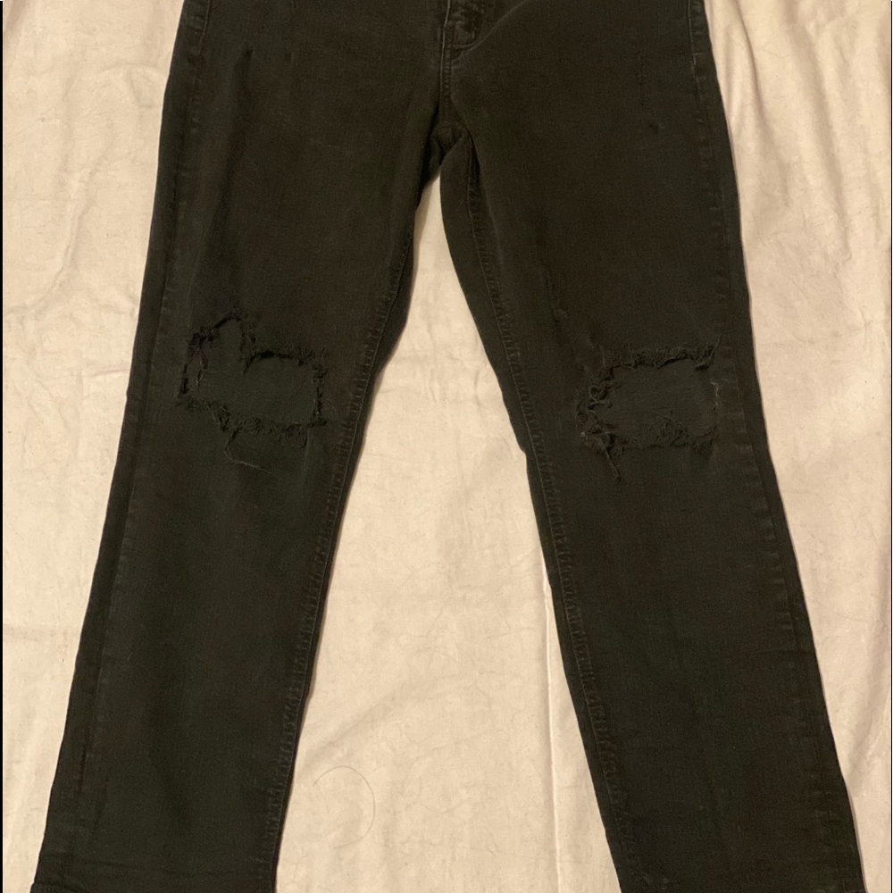 Low rise boyfriend cut size 13 jeans with distressing on knees.